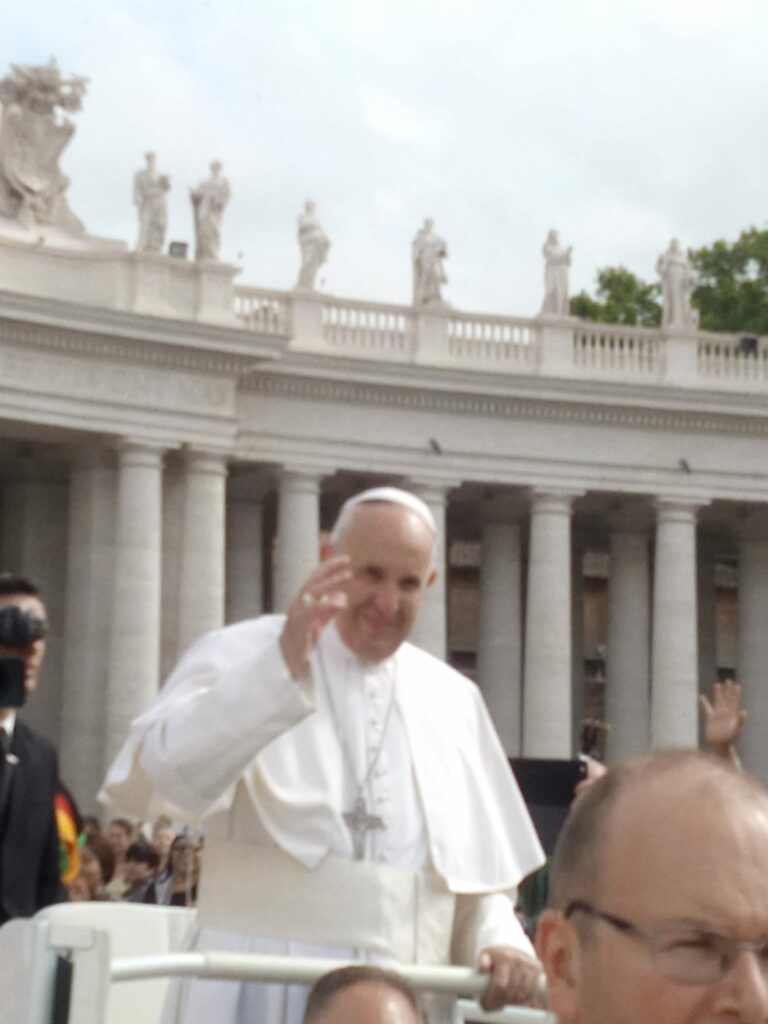 Pope Francis salutes the crowd from the Popemobile during the Papal Audience in St Peter's Square, Vatican City